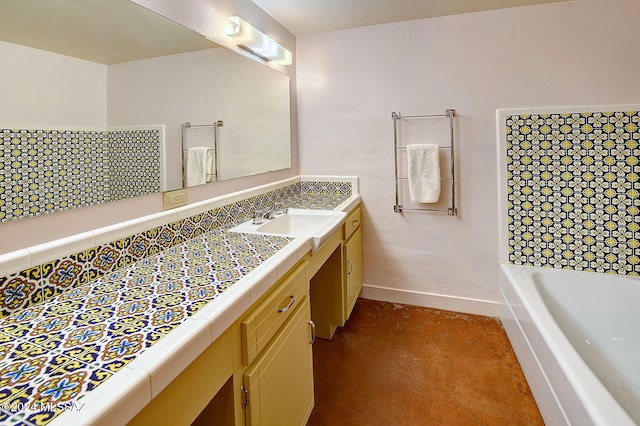 bathroom featuring concrete flooring, vanity, and a washtub