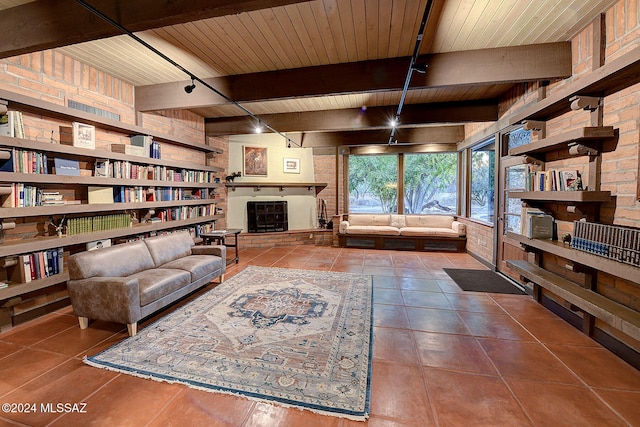 living room with beamed ceiling, wooden ceiling, and dark tile patterned flooring