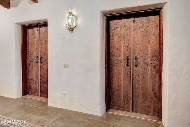 corridor with tile patterned flooring