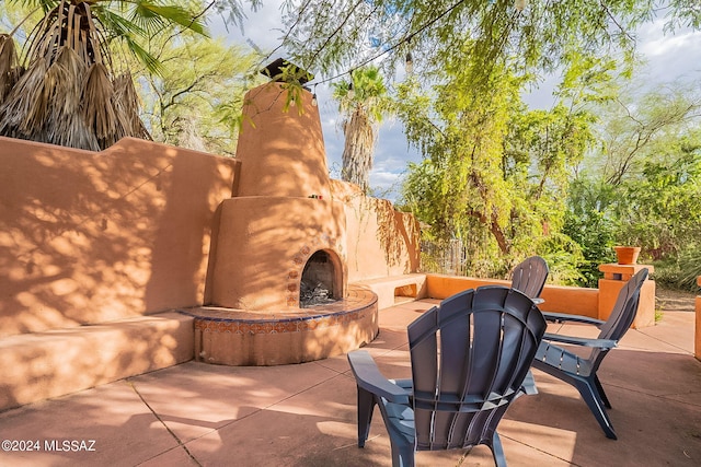 view of patio / terrace featuring an outdoor stone fireplace