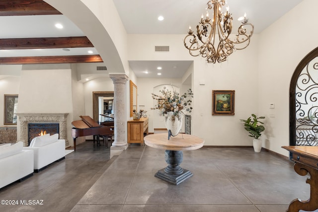 entrance foyer featuring beam ceiling and decorative columns