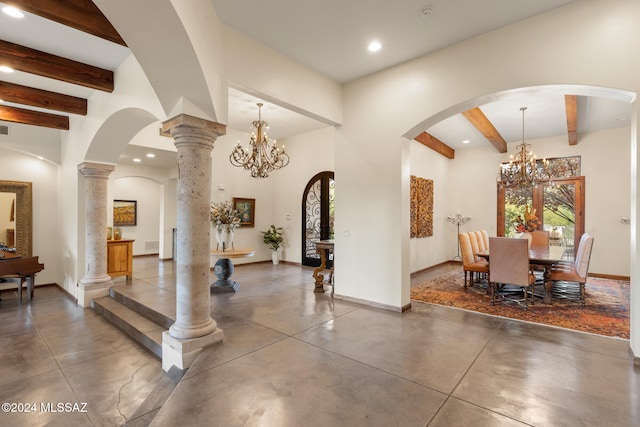 interior space featuring beam ceiling, a notable chandelier, and ornate columns