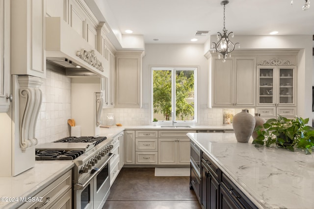 kitchen with custom exhaust hood, appliances with stainless steel finishes, pendant lighting, and tasteful backsplash