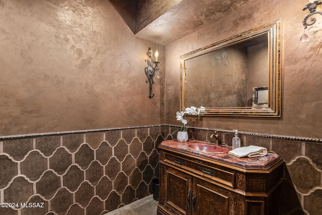 bathroom featuring tile walls and vanity