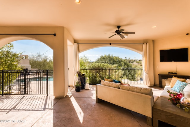 view of patio / terrace featuring ceiling fan, a fenced in pool, and an outdoor hangout area