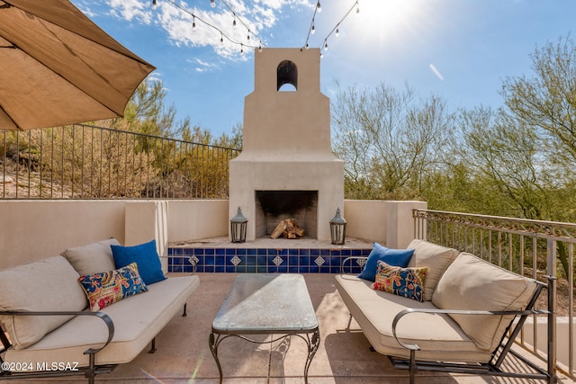 view of patio / terrace with an outdoor living space with a fireplace