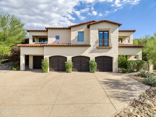 mediterranean / spanish-style house with a balcony and a garage