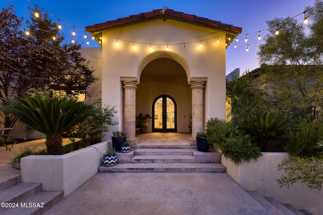 exterior entry at dusk with french doors