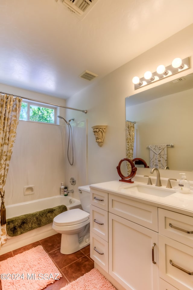 full bathroom featuring tile patterned flooring, shower / bath combo with shower curtain, vanity, and toilet