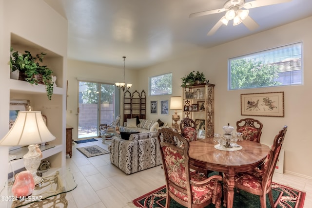 dining room featuring ceiling fan with notable chandelier and a wealth of natural light