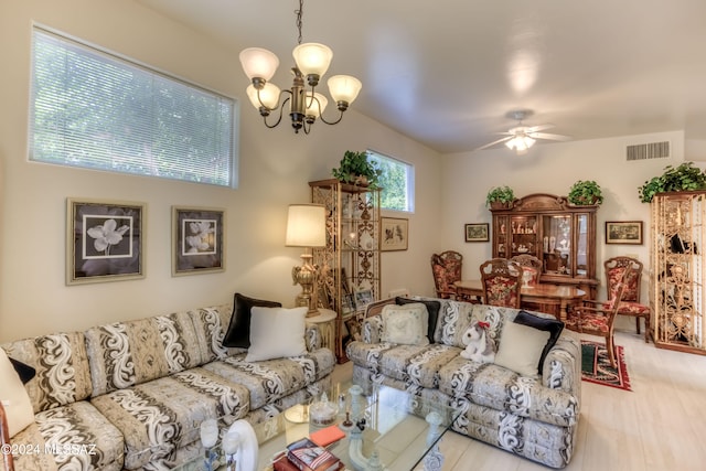 living room featuring ceiling fan with notable chandelier