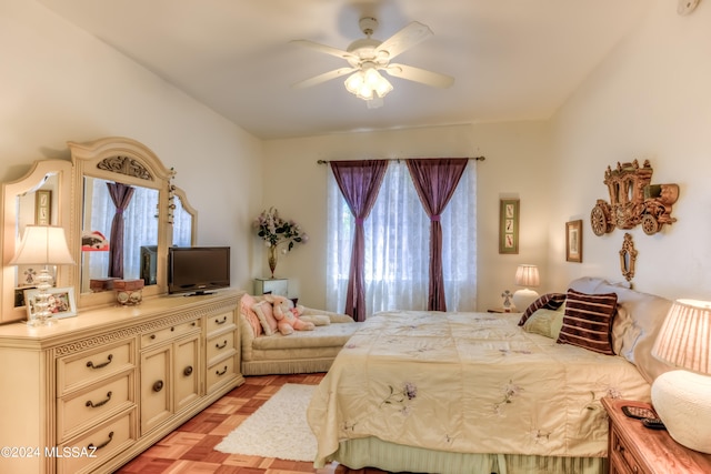 bedroom with light parquet flooring, multiple windows, and ceiling fan