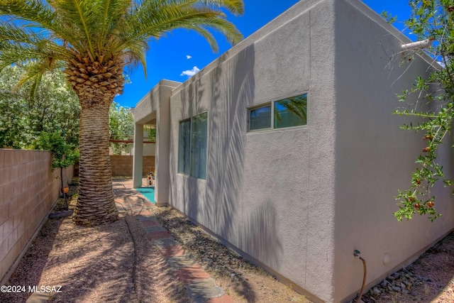 view of property exterior with a patio area