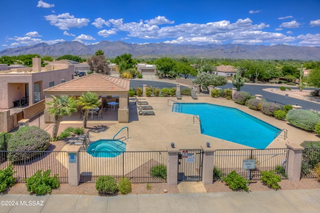 view of pool featuring a mountain view and a patio