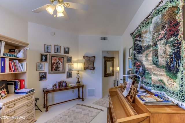 home office with light carpet and ceiling fan