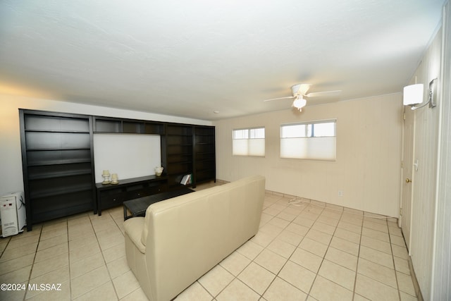 tiled living room with wood walls and ceiling fan