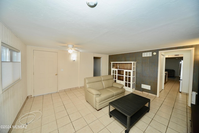 living room featuring light tile patterned floors and ceiling fan