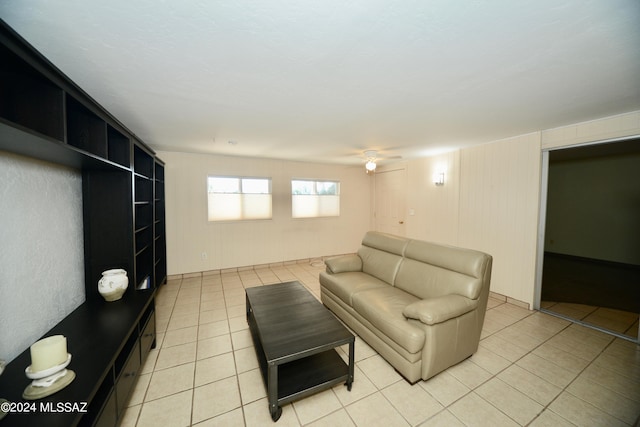 unfurnished living room with light tile patterned flooring and ceiling fan