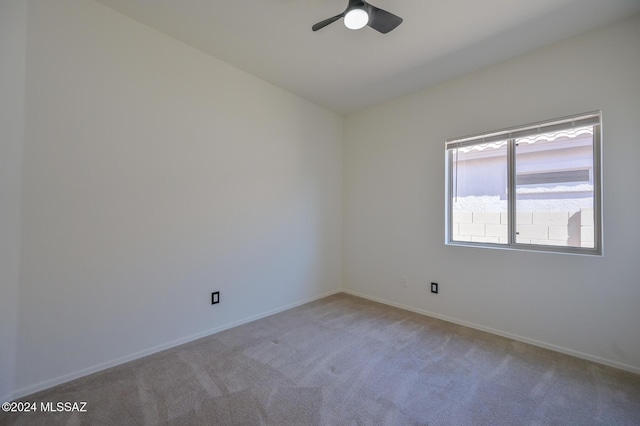 empty room featuring light carpet and ceiling fan