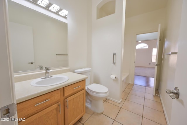 bathroom featuring tile patterned floors, vanity, and toilet