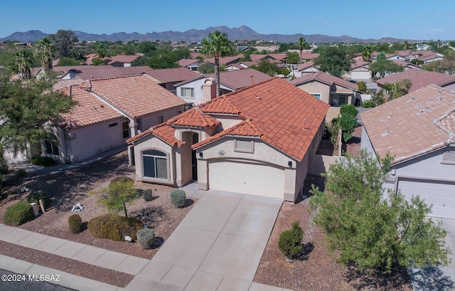 birds eye view of property with a mountain view