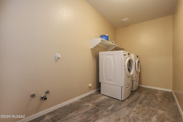 laundry room with baseboards, laundry area, and washing machine and clothes dryer