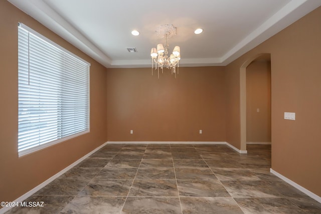 spare room featuring visible vents, baseboards, arched walkways, an inviting chandelier, and recessed lighting