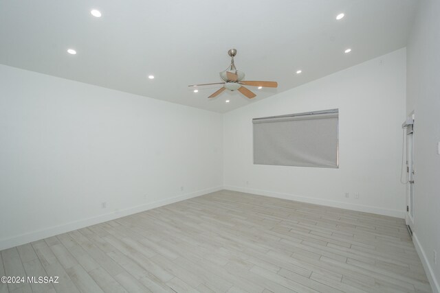 unfurnished room featuring ceiling fan, light wood-type flooring, and lofted ceiling