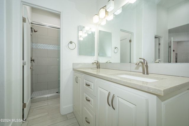 bathroom with vanity and a tile shower