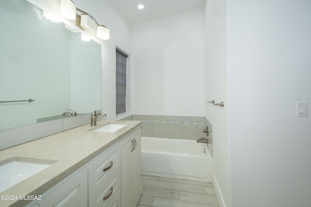 bathroom with a bathing tub and vanity