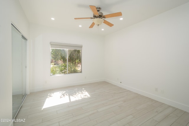 unfurnished room with light wood-type flooring and ceiling fan