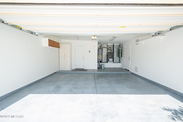 garage with water heater and a garage door opener