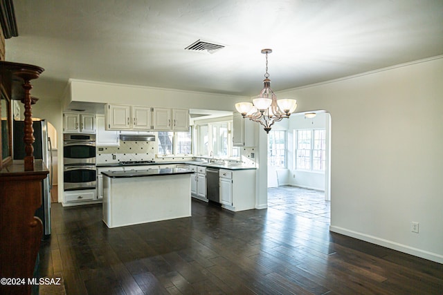 kitchen with dark hardwood / wood-style floors, appliances with stainless steel finishes, and white cabinetry