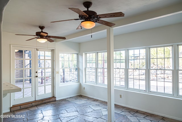 unfurnished sunroom with ceiling fan and french doors