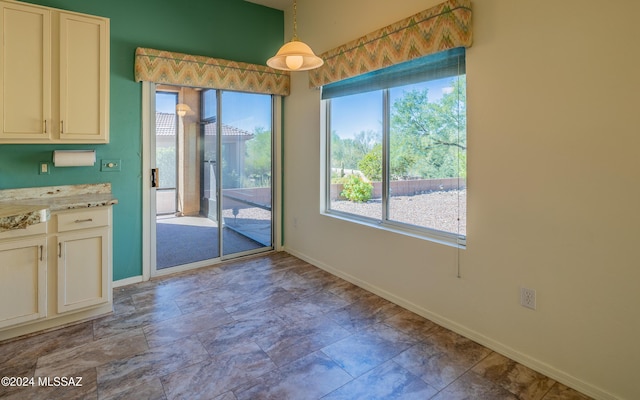 unfurnished dining area with a healthy amount of sunlight