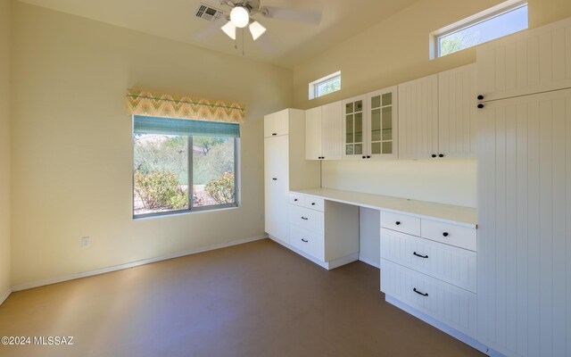 unfurnished office with ceiling fan and built in desk