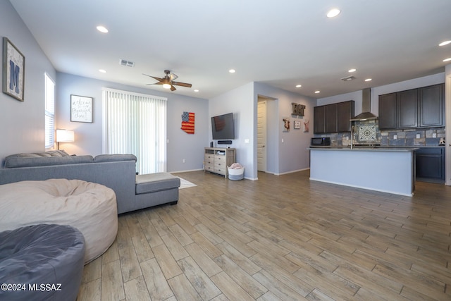 living room featuring light hardwood / wood-style floors and ceiling fan