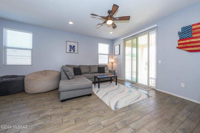 living room with wood-type flooring and ceiling fan