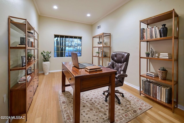 office space with light wood-type flooring and ornamental molding