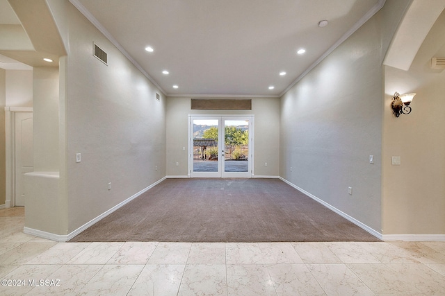 carpeted spare room featuring crown molding