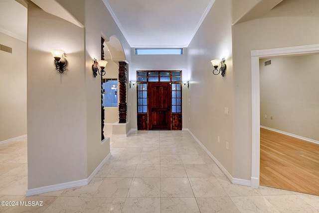 entrance foyer featuring light wood-type flooring and ornamental molding