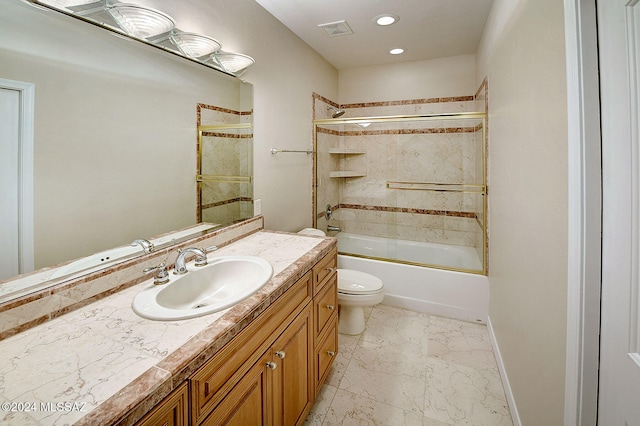 full bathroom featuring shower / bath combination with glass door, vanity, and toilet