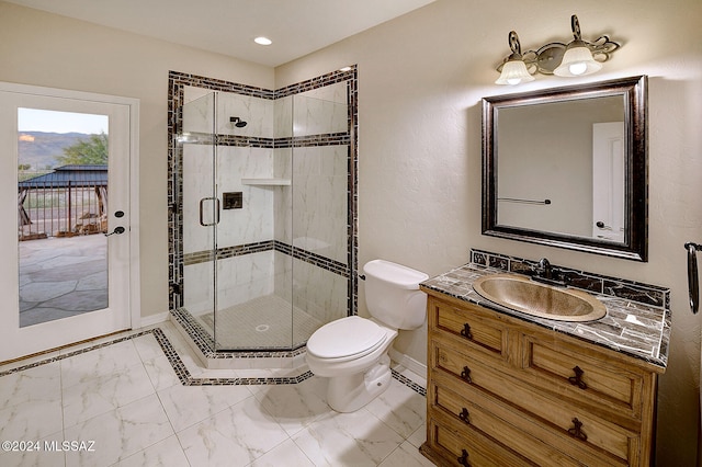 bathroom with vanity, a shower with shower door, and toilet