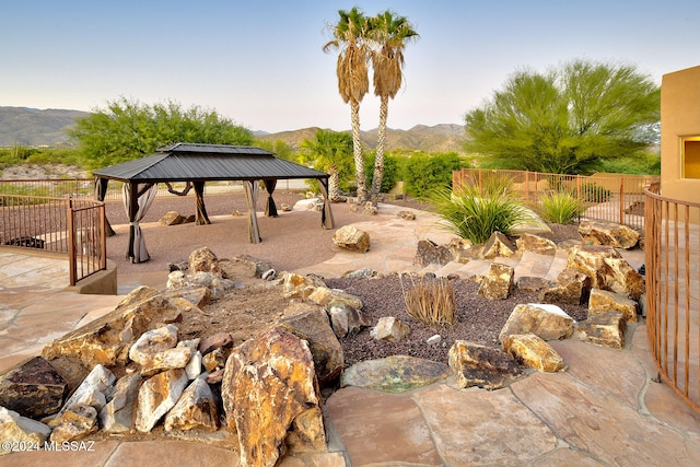 view of yard featuring a gazebo and a mountain view