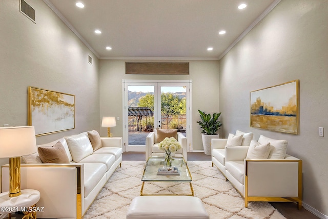 living room featuring light hardwood / wood-style floors, crown molding, and french doors