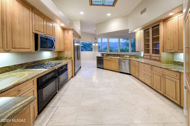 kitchen with dark stone counters, crown molding, sink, black appliances, and hanging light fixtures