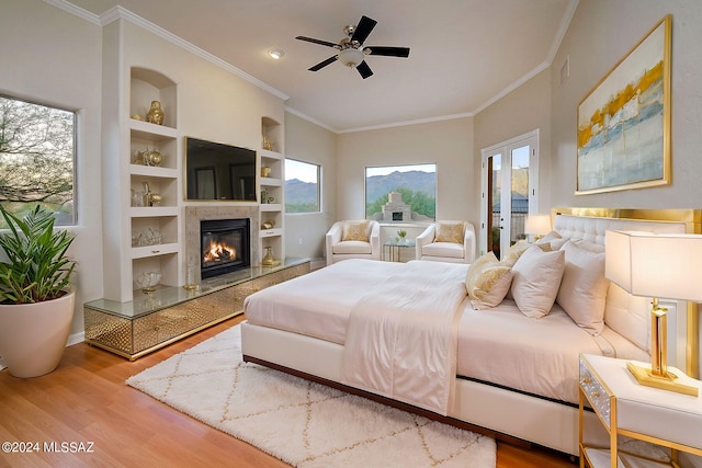 bedroom featuring light hardwood / wood-style floors, multiple windows, and crown molding