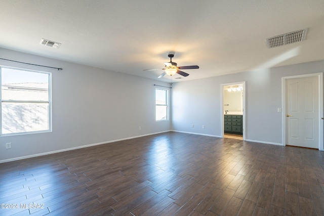 empty room featuring ceiling fan and dark hardwood / wood-style floors