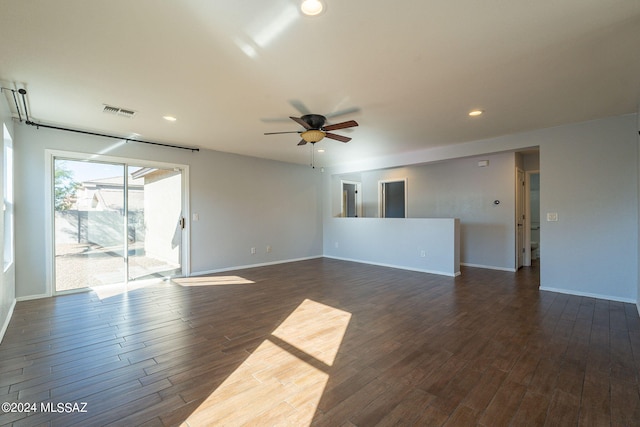 empty room featuring dark wood-type flooring and ceiling fan