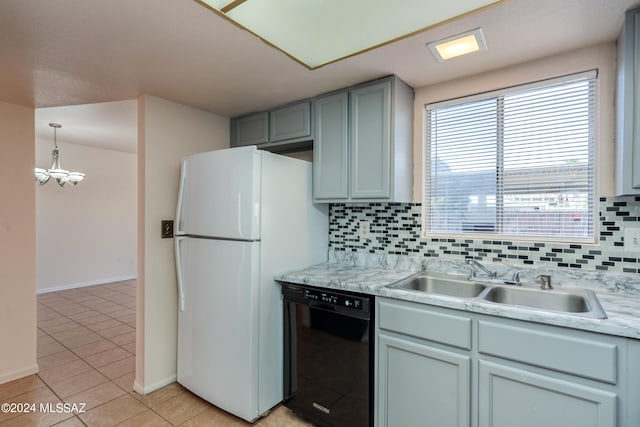 kitchen featuring decorative backsplash, white refrigerator, black dishwasher, and sink